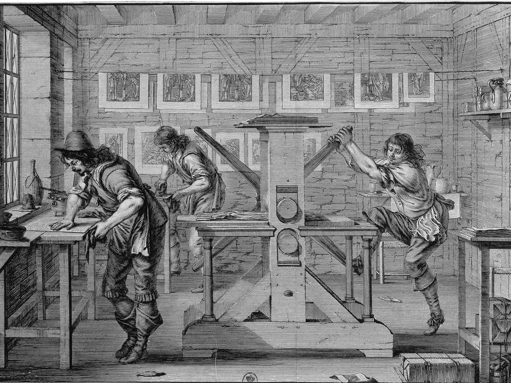 Abraham Bosse’s engraving of a printmaker’s workshop: three craftsmen at their stations around a press, finished plates hanging along the wall behind them